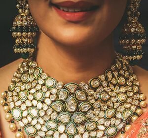 a smilling woman with big necklace