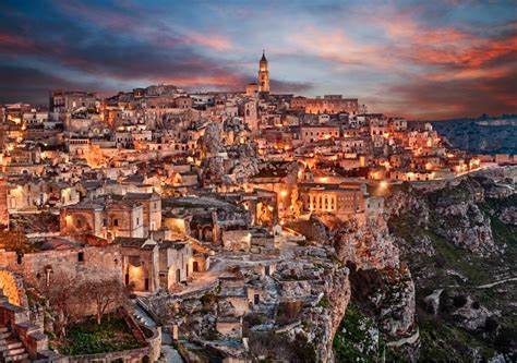 Matera lit up by street lights as night draws in