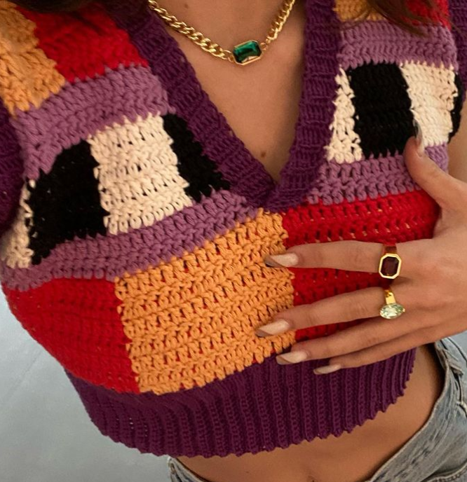 Emma in her chunky knit top and flashing a brilliant jewellery ensemble