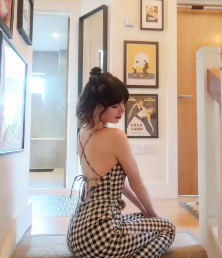 Jane wearing a black and white check jumpsuit