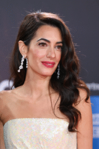 Person in strapless dress and dangling earrings.