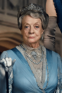 Person in a blue dress and tiara holds a cane.