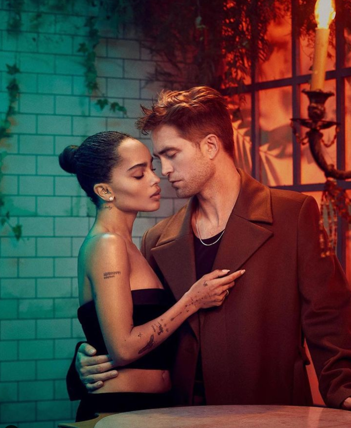 Two people embrace; one in a strapless top, the other in a jacket.