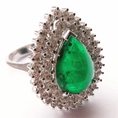 Ring with a large, teardrop-shaped green stone surrounded by small, clear stones.