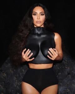 Person in black top and shorts holds hands to chest.